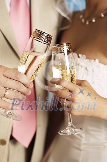 Bride and groom having a glass of champagne