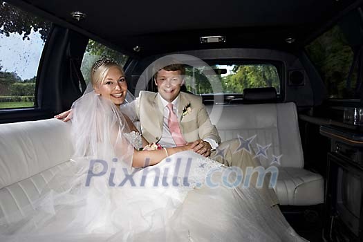Bride and groom in the limousine