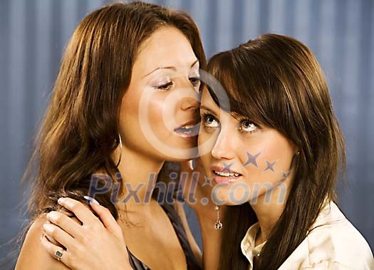 Two women telling a secret