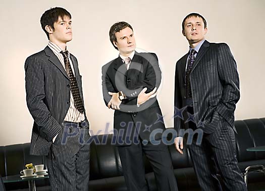 Three businessmen standing Three businessmen standing