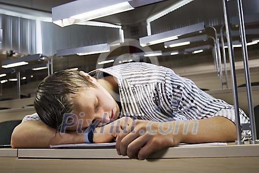 Boy sleeping in the classroom