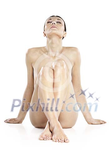 Naked woman sitting on the ground