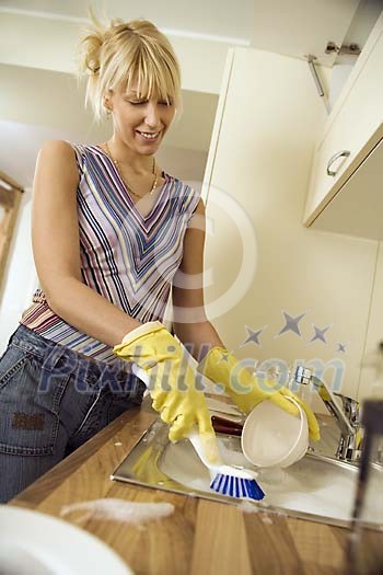 Woman in the kitchen doing the dishes
