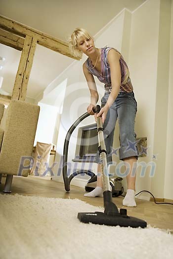 Woman vacuuming the floor