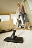 Woman vacuuming the carpet