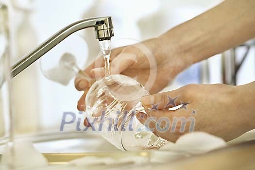 Woman hands wasing a glass