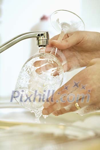 Woman hands wasing a glass