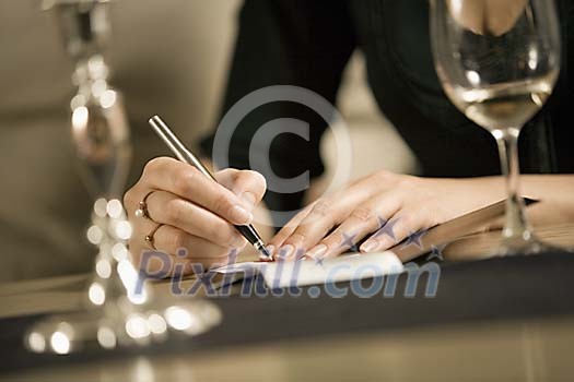 Woman signing a bill