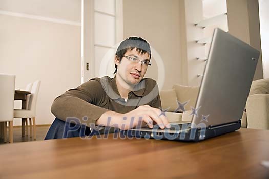 Man with laptop at home