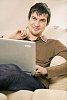 Man sitting on the couch with laptop