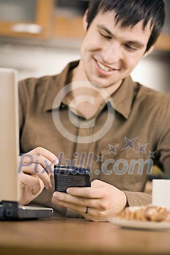 Man sitting on the table looking at his phone