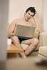 Man sitting on the couch looking at his laptop