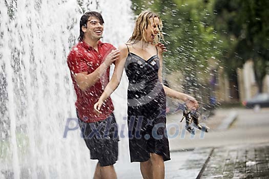 Couple having fun in the fountain