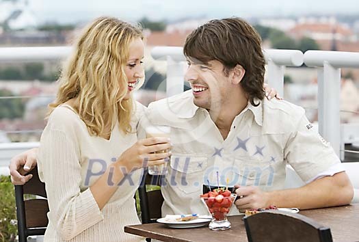 Couple having a snack in the outdoor cafeteria Couple having a snack in the outdoor cafeteria