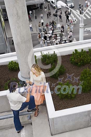 Couple having champagne outdoors