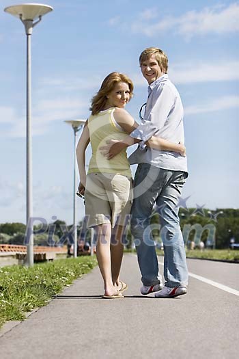 Couple walking on the sidewalk