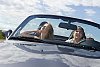 Couple driving in convertible car