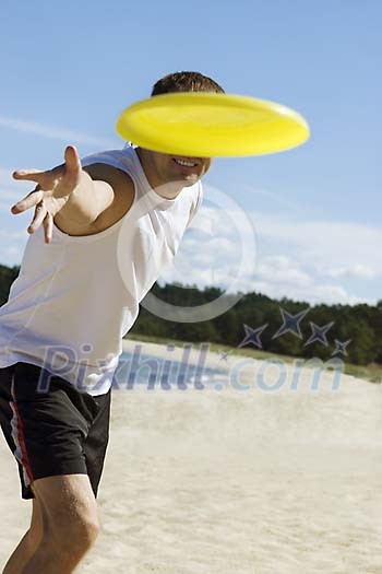 Man throwing a frisbee at the camera