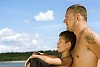 Man and a boy sitting on the beach