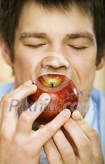 Man taking a bite of apple