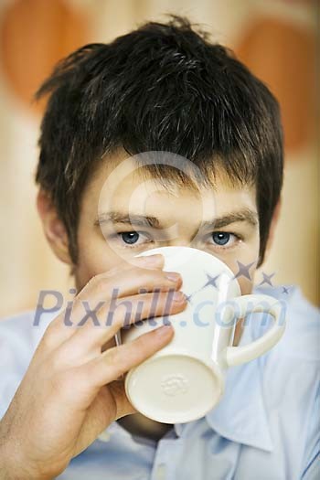 Man holding a cup and drinking