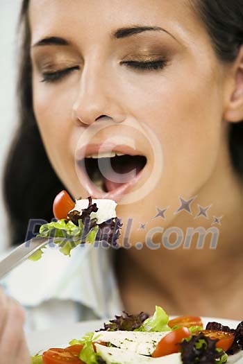 Woman eating salad