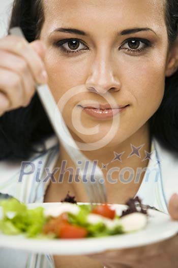 Woman holding a plate of salad