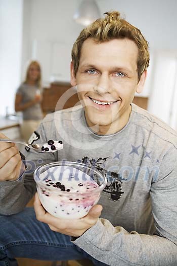 Man eating a bowl of dessert