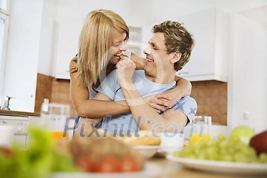 Man feeding woman