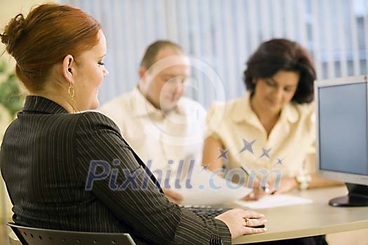Two women and a man having a meeting