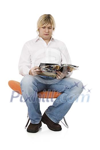 Man sitting and looking through the magazine