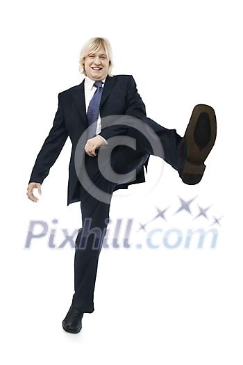 Businessman kicking on a white background