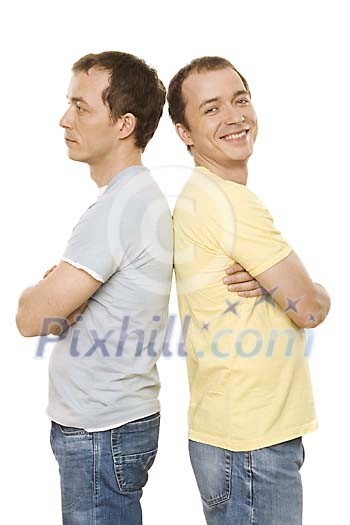 Male twins standing back to back Male twins standing back to back