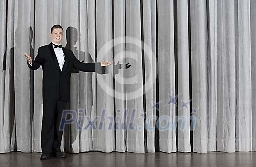 Man standing alone on a stage Man standing alone on a stage