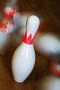 Closeup of bowling pins falling