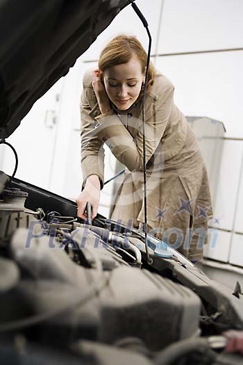 Woman checking under the hood Woman checking under the hood