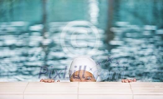 Older woman peeking in the pool Older woman peeking in the pool