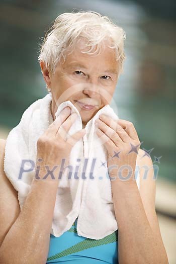 Older woman drying herself