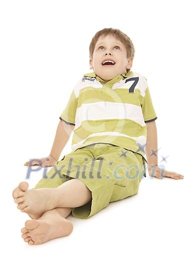 Boy sitting on the ground, looking up