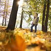 Man walking in the forest on a sunny autumn day