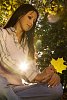 Woman sitting and holding a maple leaf