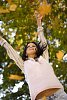 Woman throwing leaves in the air