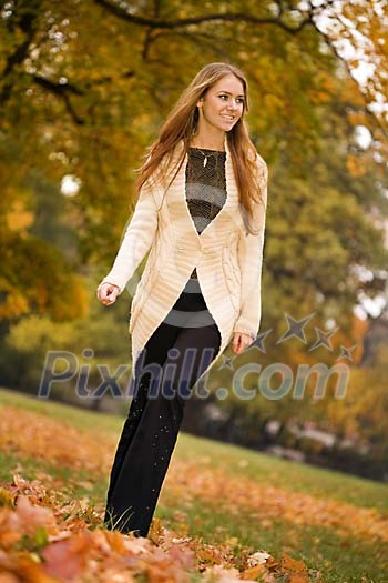 Woman walking alone in the park Woman walking alone in the park