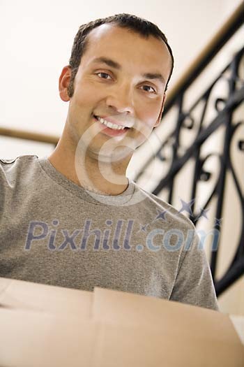 Portrait of a man carrying a box