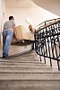 Man and woman carrying a sofa up the stairs