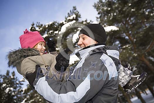 Man and child outside in the snow
