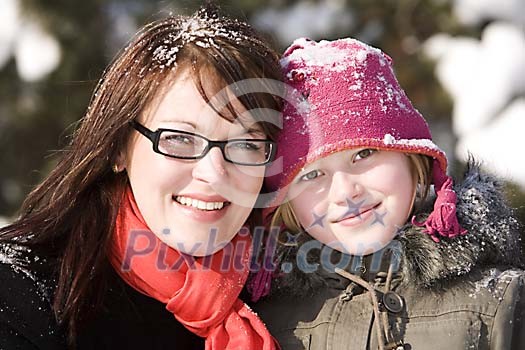 Mother and daughter outside at winter
