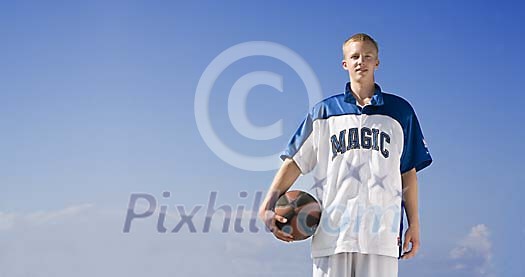 Boy standing with basketball