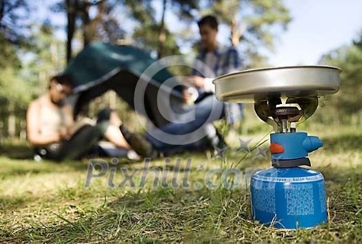 Camping cooker with a blurred people on the background Camping cooker with a blurred people on the background
