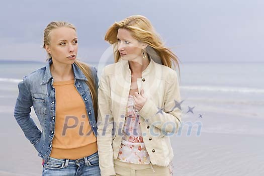 Two women talking at the beach